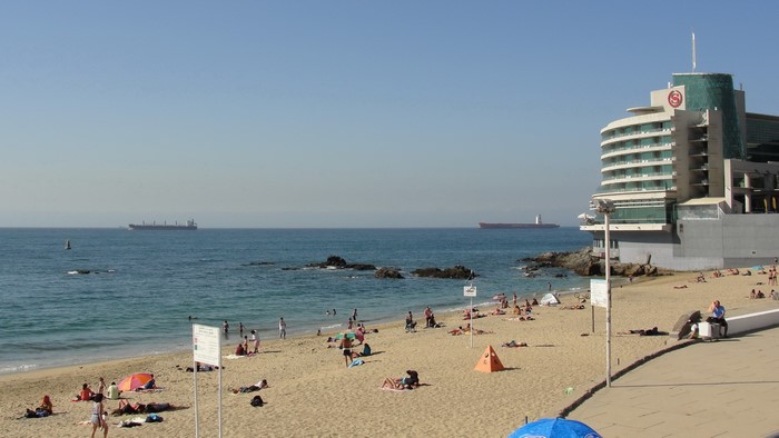 Beach with hotel and ships in Valparaiso, Chile