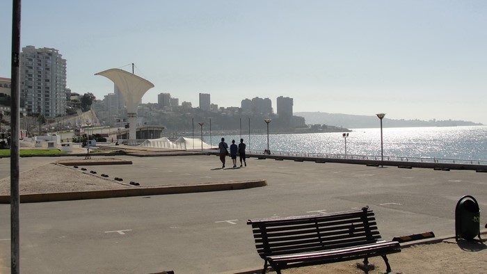 People walking by the sea in Valparaiso, Chile