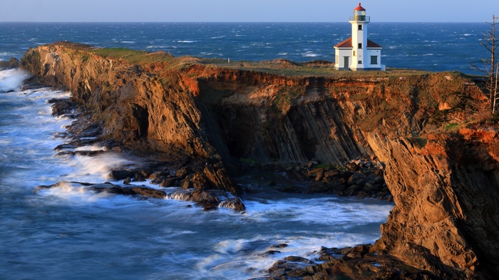 Cape Meares Lighthouse on a cliff overlooking the ocean