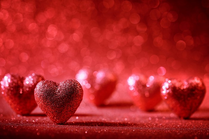Red Glitter Hearts on Red Bokeh Background