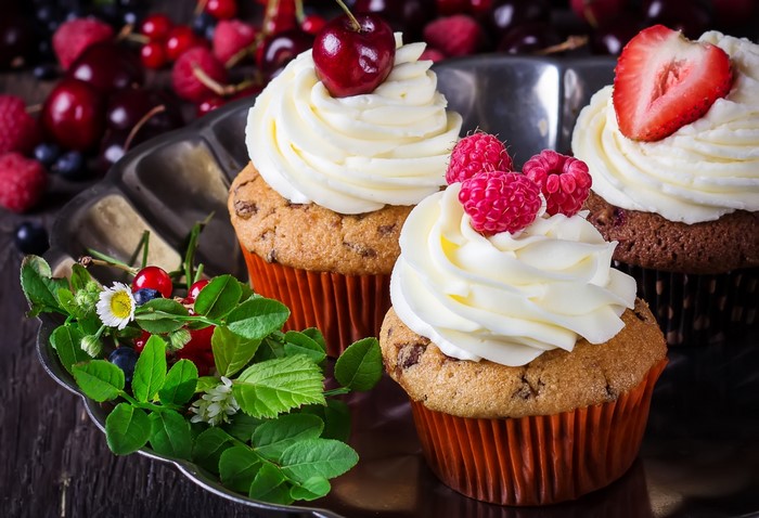 Cupcakes with assorted berries and frosting