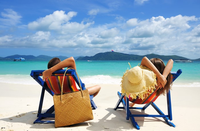 Couple Relaxing on Beach Chairs by the Ocean