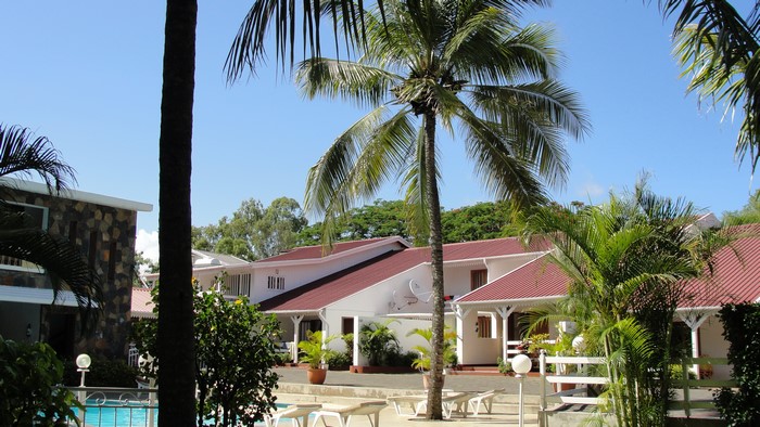Tropical resort with palm trees and swimming pool