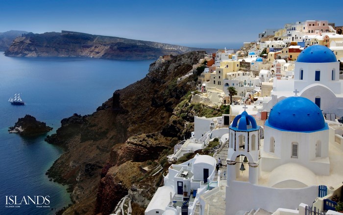 Santorini Greece Coastline with Blue Domed Churches and Sailboat