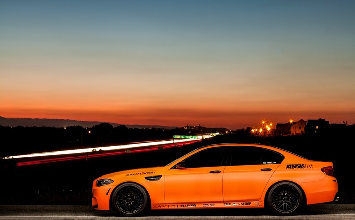 Orange BMW M5 F10 on a Highway at Sunset
