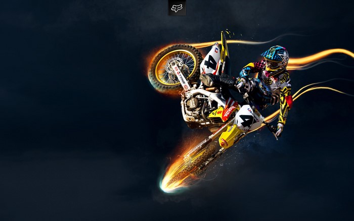 Motocross Rider Performing a Jump with Fire Effects