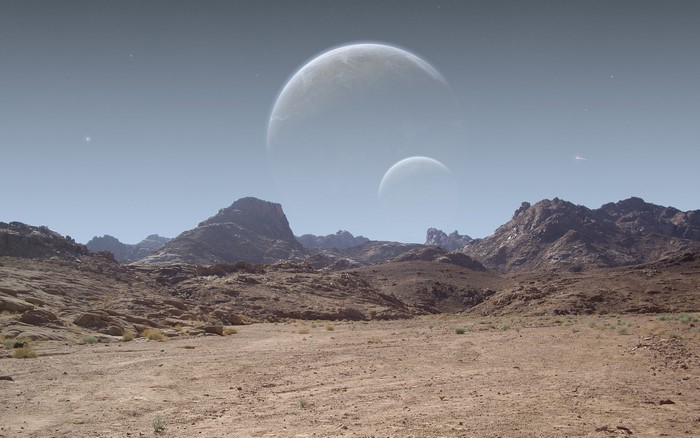 Desert landscape with two moons in the sky