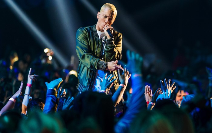 Eminem performing on stage at a concert