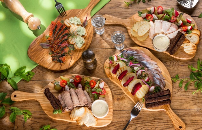 Assortment of appetizers with smoked salmon, herring, and meat