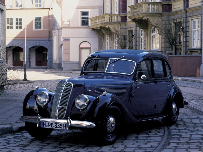 Blue BMW retro car on cobblestone street
