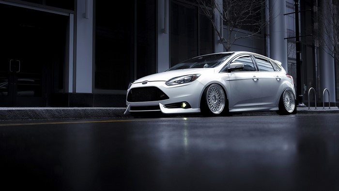 White Ford Focus ST Avant Garde parked on wet street