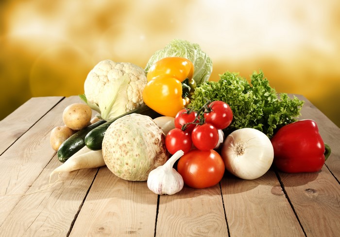 Assortment of fresh vegetables on a wooden table