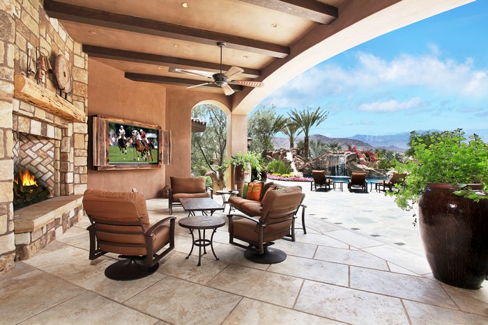 Outdoor patio with fireplace and pool