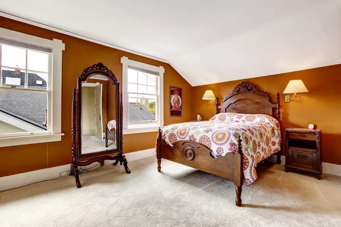 Bedroom with wooden bed and mirror
