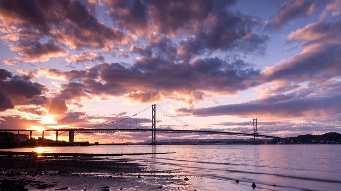 Forth Bridge at sunset over water
