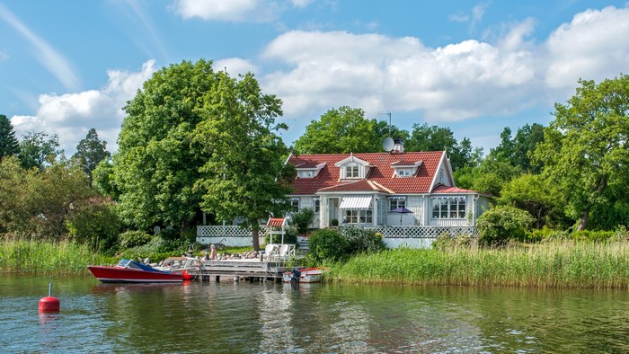 House with motorboat on river in Vaxholm, Sweden