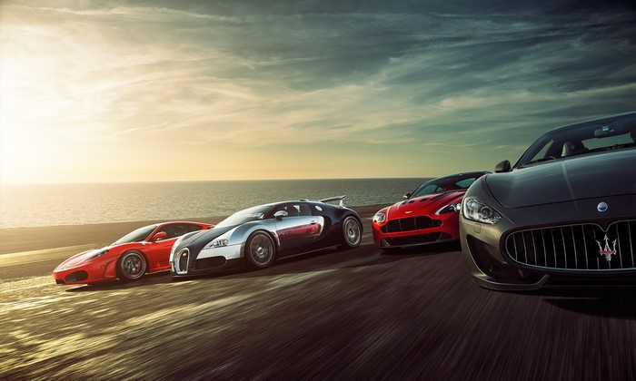 Ferrari, Bugatti, Aston Martin, and Maserati supercars on road