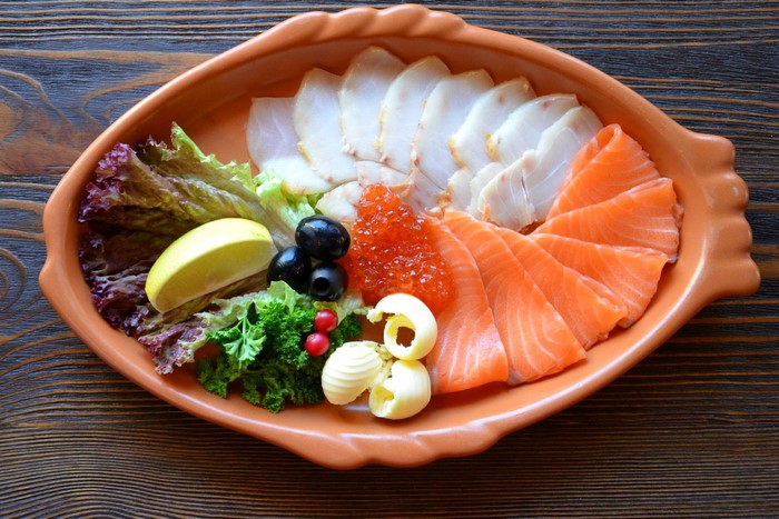 Seafood platter with salmon, white fish, caviar, and butter