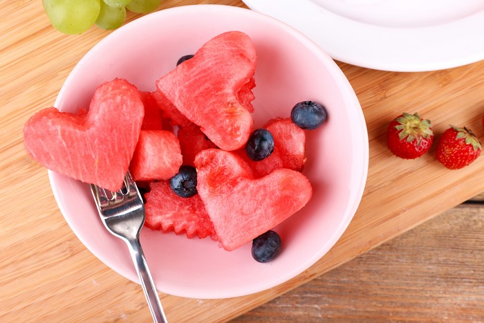 Heart-shaped watermelon with blueberries and strawberries
