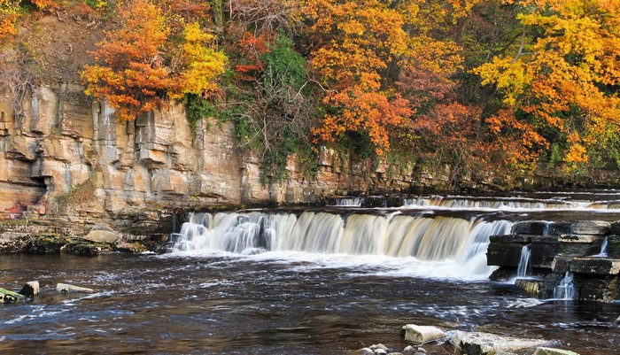 Waterfall in Autumn with Rocky Cliffs