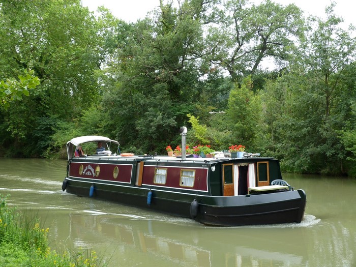 Riverboat on a canal surrounded by trees
