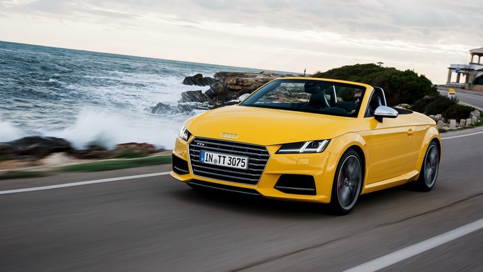 Yellow Audi TTS Roadster driving by the sea