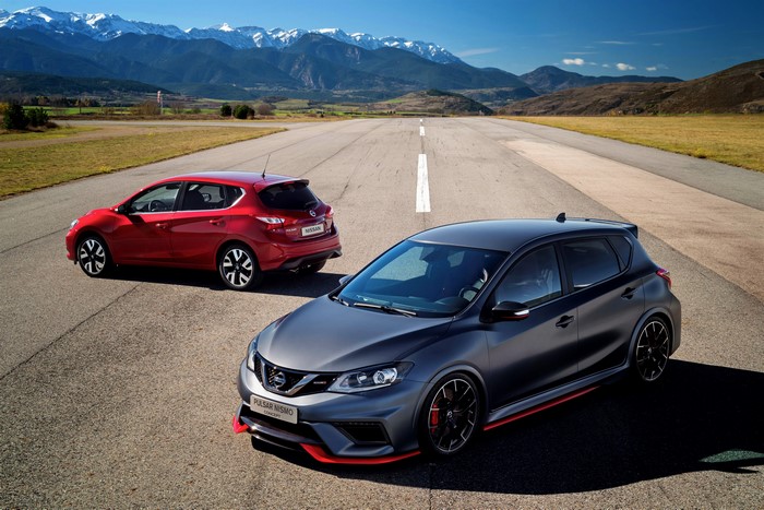Two Nissan Pulsar Nismo Concept cars on a road with mountains