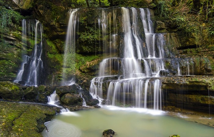 Cascading waterfalls in a lush forest