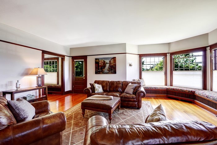 Living room with leather sofas and bay windows
