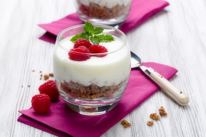 Yogurt parfait with raspberries and granola in a glass