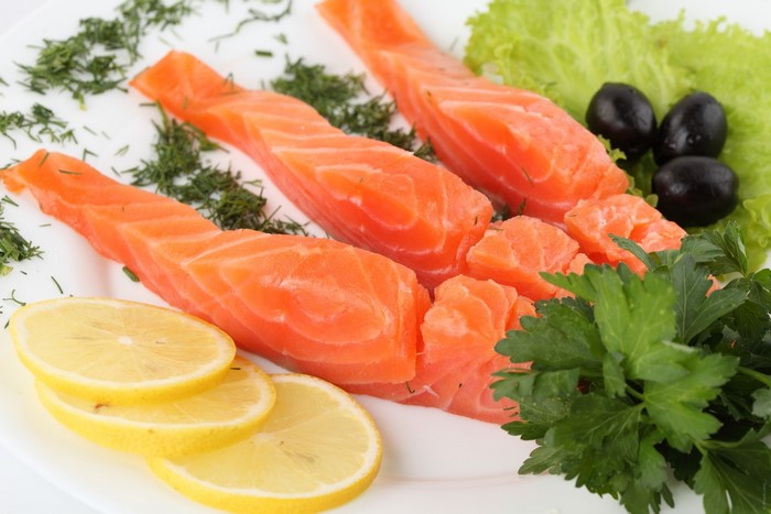 Salmon fillets with lemon, olives, and herbs