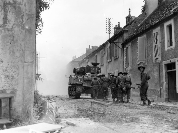 Sherman tank and soldiers in a European town