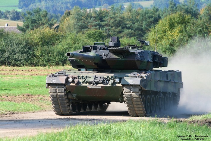 Leopard 2 A6 tank driving on a dirt road