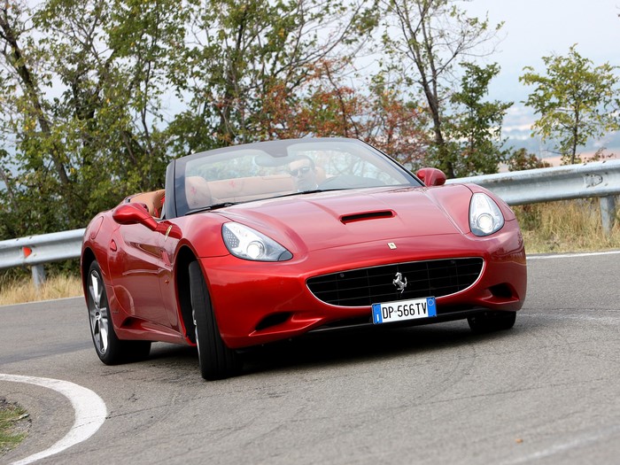 Red Ferrari California Cabriolet on a Winding Road