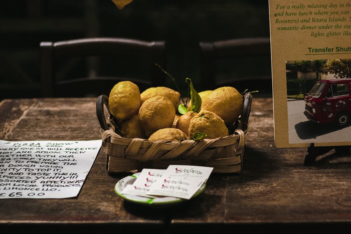 Lemons in a wicker basket on a table