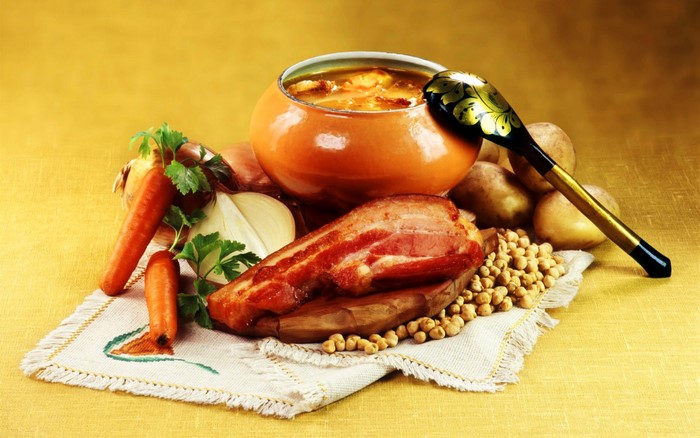 Still life of soup, bacon, vegetables, and potatoes