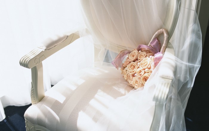 Wedding bouquet on a chair with veil