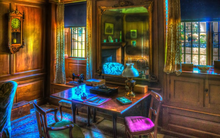 Vintage room with desk, sewing machine, and clock