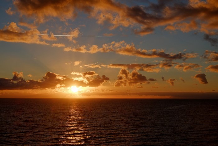 Sunset over the ocean with clouds