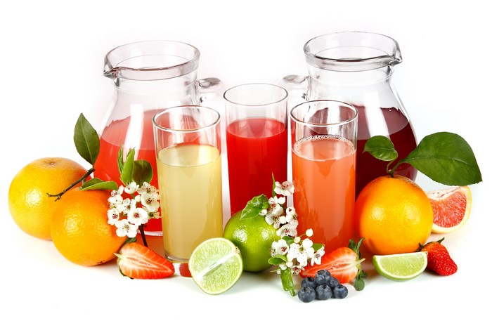 Assorted Fruit Juices in Pitchers and Glasses with Fresh Fruit