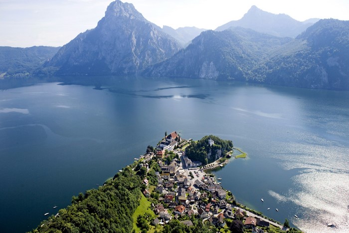 Traunkirchen village on a peninsula in a lake with mountains