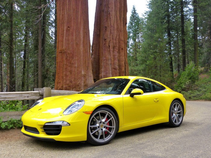 Yellow 2012 Porsche 911 Carrera S in a forest