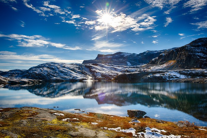 Lake and Mountains with Sun and Clouds