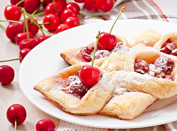 Cherry pastries with powdered sugar and fresh cherries