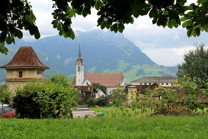 Village with church and mountains in Schwyz, Switzerland