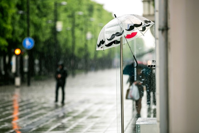 Umbrella with mustache and lips design in the rain