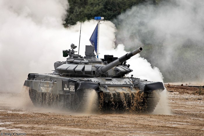 T-72B3 tank driving through mud and smoke