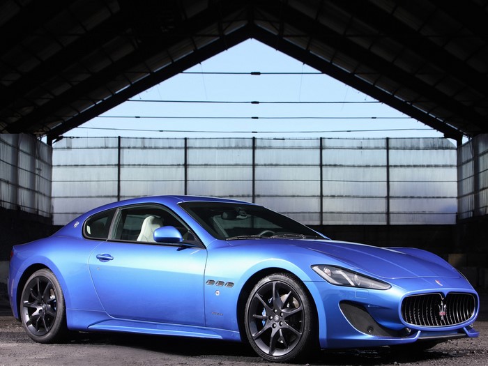 Blue Maserati GranTurismo in a warehouse