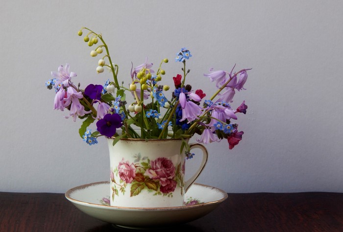 Bouquet of wildflowers in a teacup on a saucer