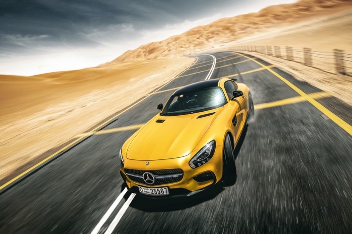 Yellow Mercedes-Benz AMG GT S driving on desert road